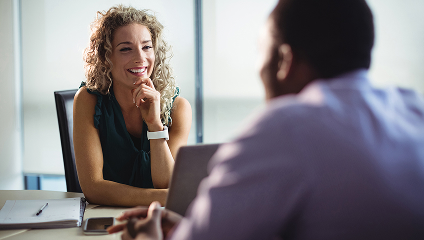 business woman smiling in a meeting